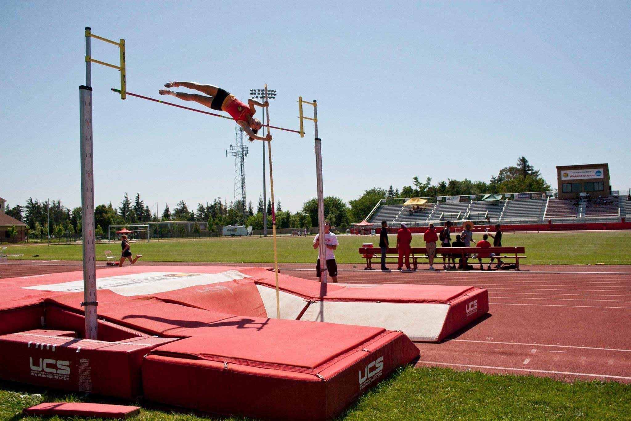 Athlete clearing a pole vault bar