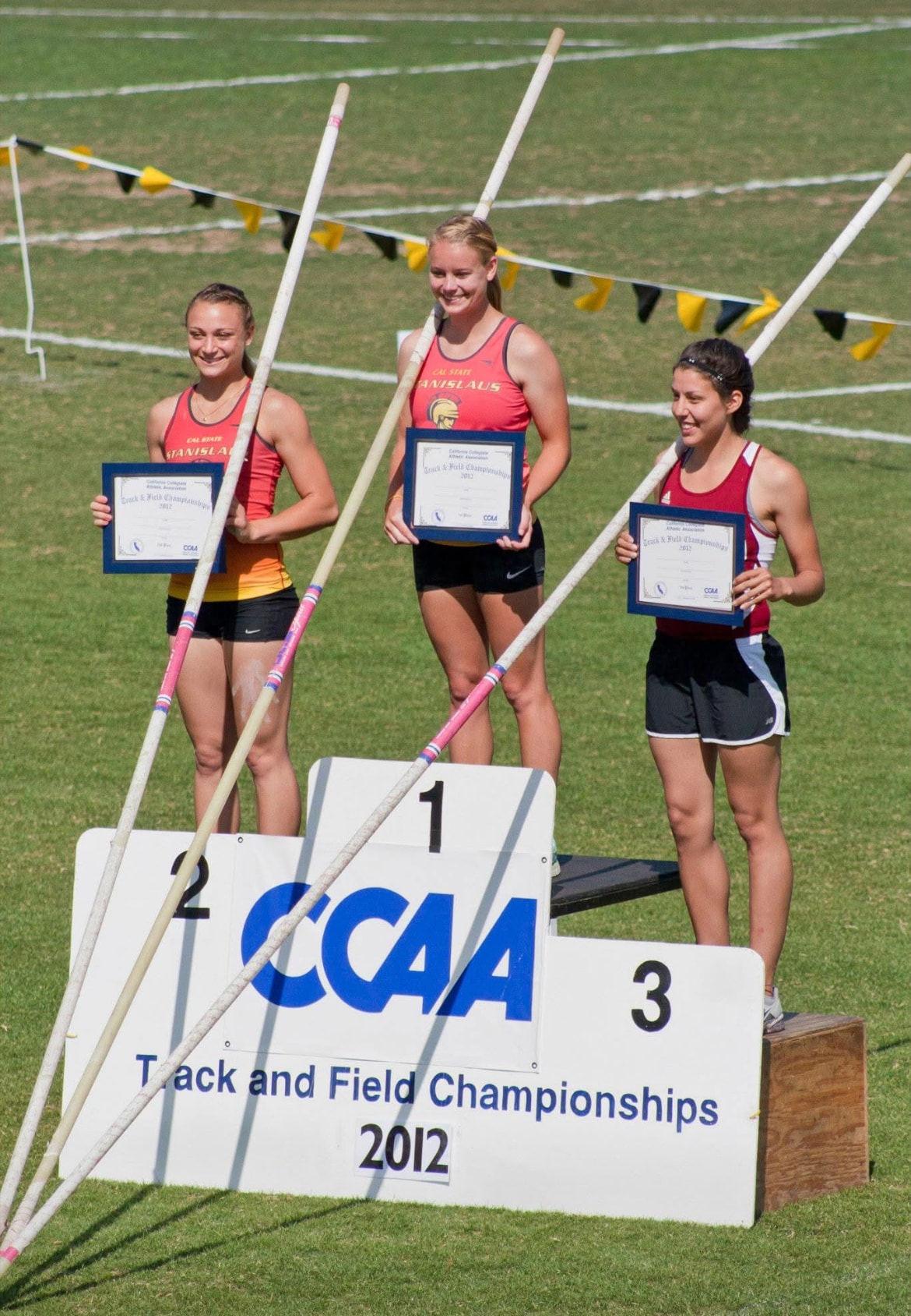 Pole vault medalists holding certificates