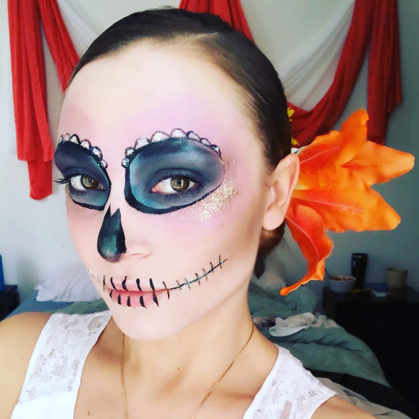 Kristy wearing sugar-skull makeup and orange flowers